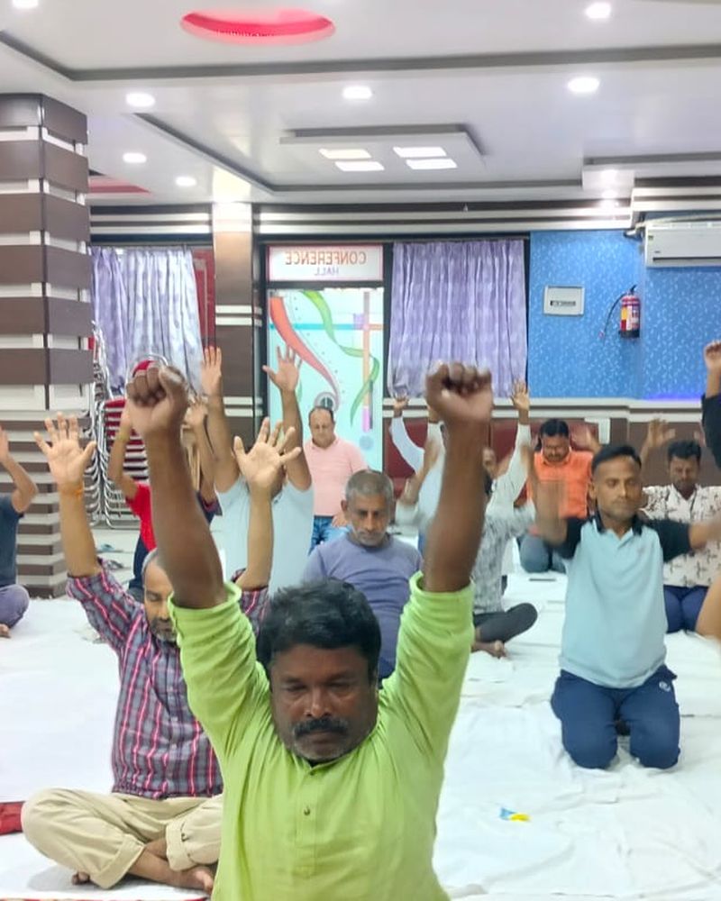 A group yoga class led by Mukesh